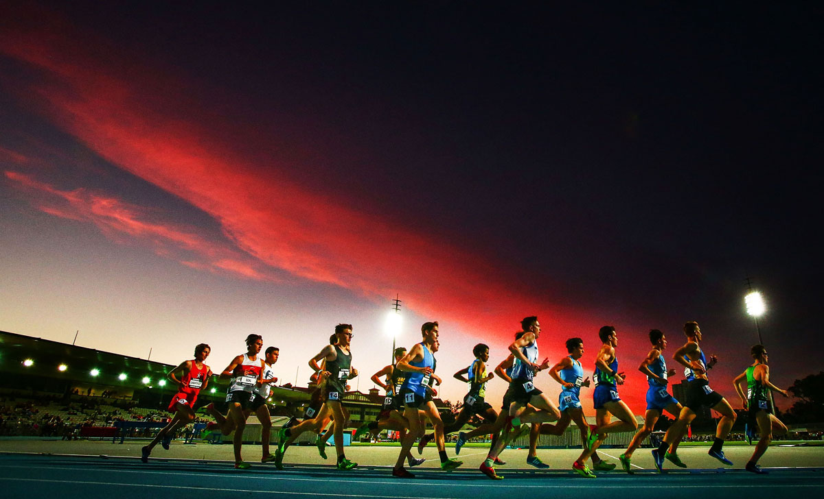 The sun sets during the Men's 3000m Under 20 race during the Zatopek 10 meet at Lakeside Stadium in Melbourne.