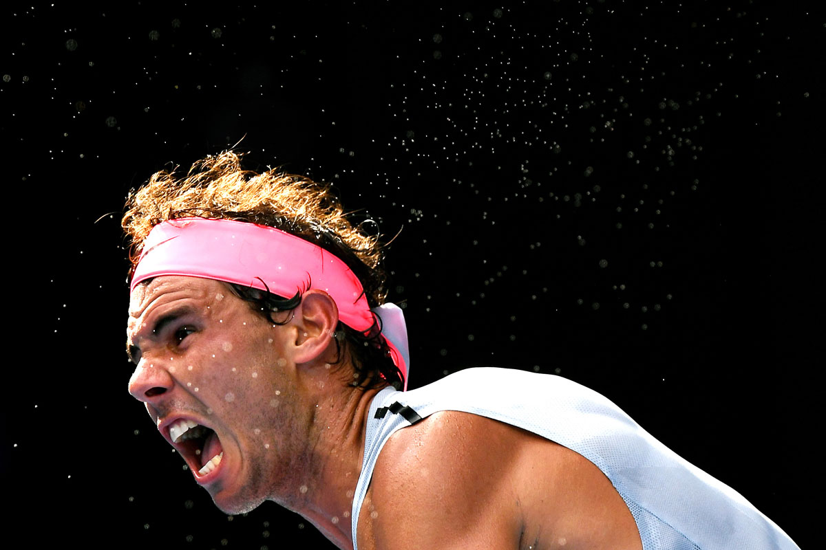 Beads of sweat fly off Spain’s Rafael Nadal as he serves to Argentinian Diego Schwartzman in round four of the Australian Open in Melbourne.