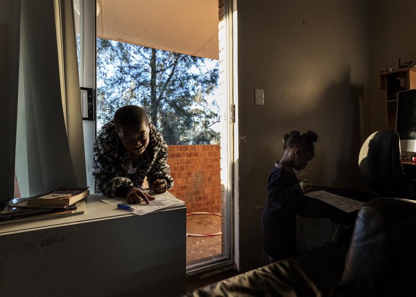Anna Maria Antoinette D'Addario, Lamin Tucker's children, Francis and Rachael draw in their house after school